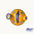 Ceramic dish with blue floral patterns on a yellow background, featuring the El Cangrejo logo.