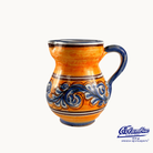 Ceramic pitcher with orange and blue design on a white background