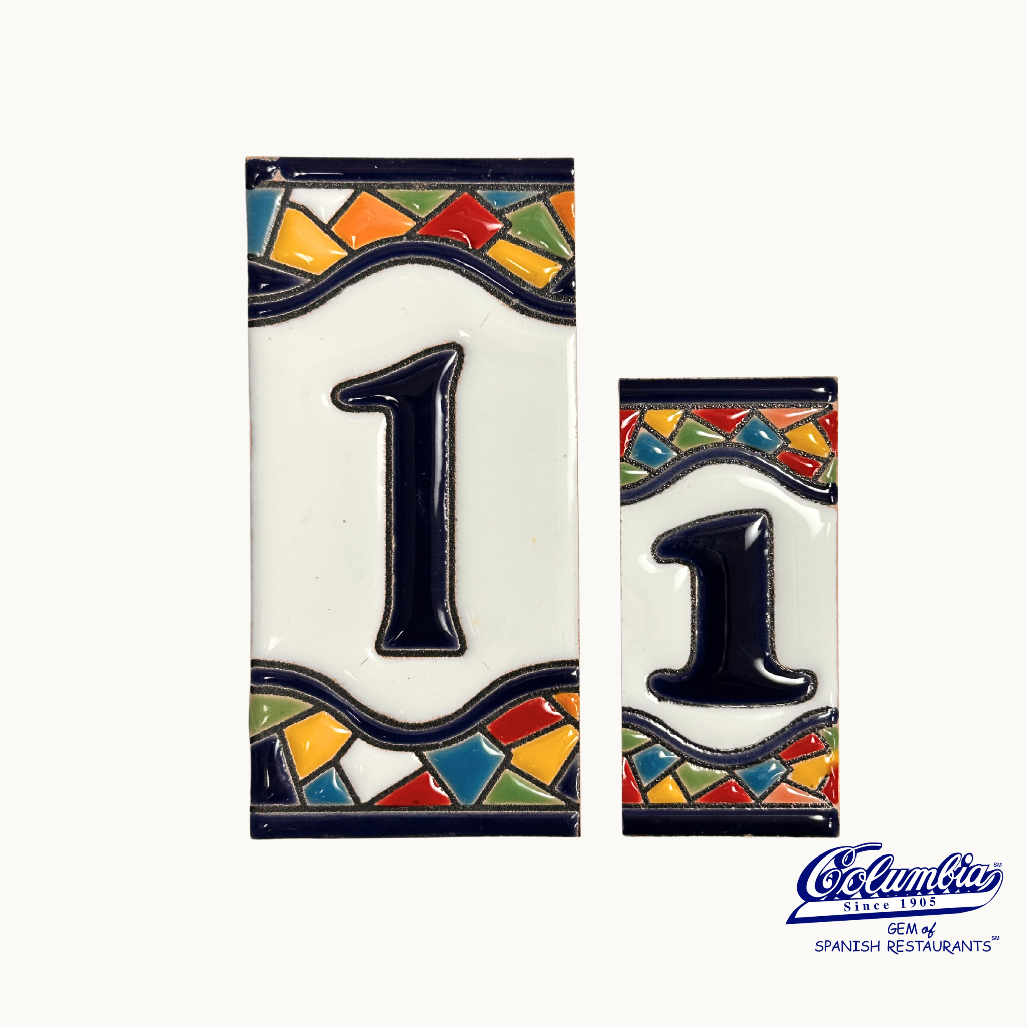Two ceramic tiles with the number '1' on a white background, featuring colorful mosaic designs.